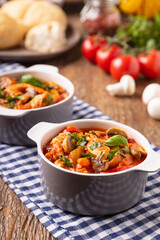 Chicken stew with peppers, mushrooms and tomatoes.