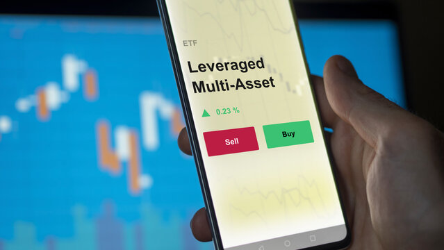An Investor's Analyzing The Leveraged Multi-asset Etf Fund On A Screen. A Phone Shows The Prices Of Leveraged, Leverage Multi Asset To Invest
