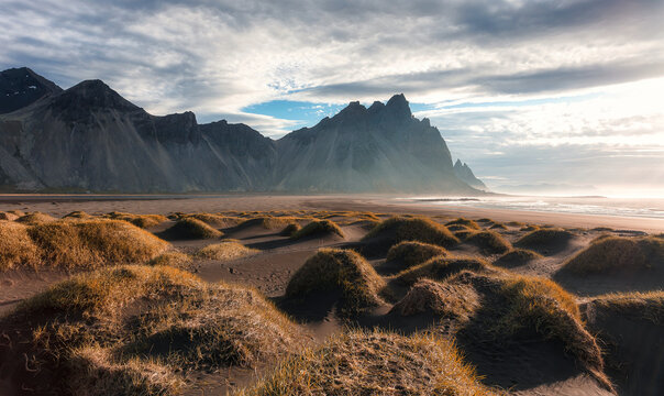 Scenic image of famous Stokksnes cape and Vestrahorn Mountain with  colorful dramatic sky during sunset in Iceland. Iconic location for landscape photographers. Amazing nature of World.