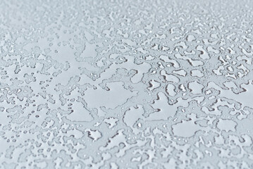 Water drops condensate on white background texture on transparent glass. backdrop glass covered with abstract drops of water.Selective focus.