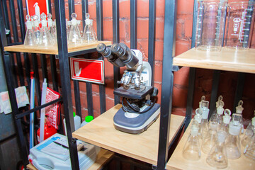 Electron microscope stands on the shelf of the scientific laboratory