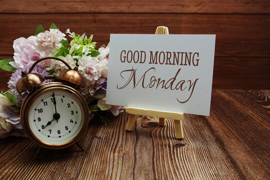 Good Morning Monday text on paper card on wooden background
