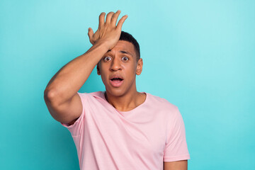 Photo of impressed shocked young guy wear pink t-shirt arm forehead forget important thing isolated...