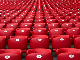 Numbered red bleacher seats in a stadium