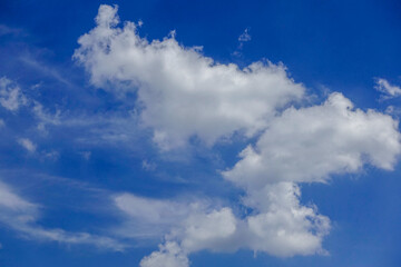 Naklejka na ściany i meble Puffy fluffy white clouds blue sky.
