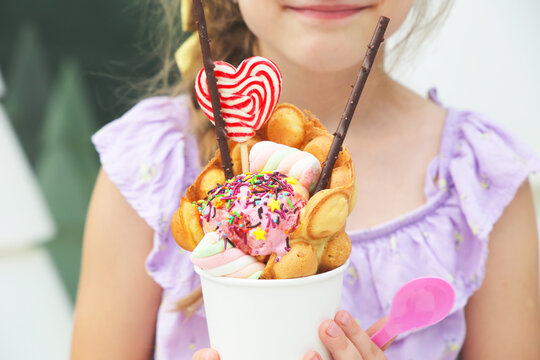 Girl and her ice cream in bubble waffle cones