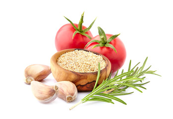 Fresh tomatoes  with  garlic and rosemary isolated on white background. Granulated garlic  in wooden bowl.
