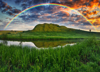 Landscape with a Rainbow on the River in Spring. colorful morning. nature of Ukraine