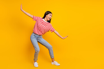 Fototapeta na wymiar Full size portrait of overjoyed cheerful person arms make funny pose look empty space isolated on yellow color background