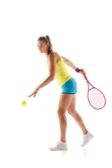 Portrait of young woman, professional tennis player training, serving ball isolated over white studio background