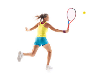 Portrait of young sportive woman, professional tennis player hitting ball with racket, training...