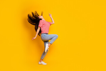 Fototapeta na wymiar Full size profile portrait of overjoyed satisfied lady flying black hairdo dancing isolated on yellow color background