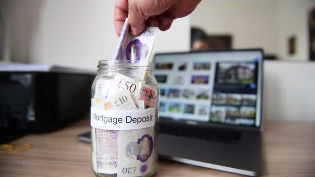 A person saving money towards a mortgage deposit in order to get on the property ladder and buy a home.