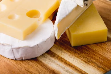 Foto op Plexiglas High angle close-up of various cheese on wooden board, copy space © WavebreakMediaMicro