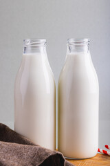 Close-up of milk bottles against gray background with copy space
