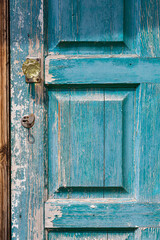 fragment of closed old wooden door with peeling paint