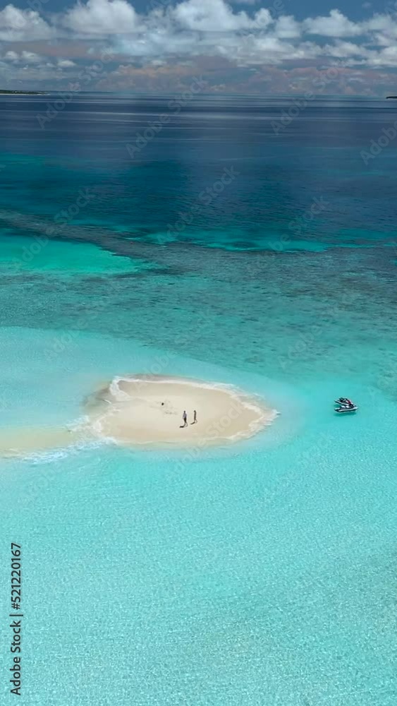 Canvas Prints Vertical aerial drone footage of couple walking in a beach