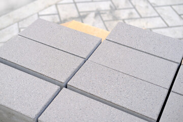 gray paving blocks on the ballast, side view, construction site of pavement modern granite...