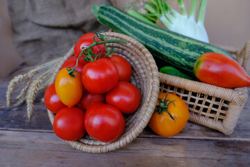 ripe vegetables in basket, tomatoes, cucumbers, zucchini, celery, ears of grain on retro background,burlap, harvest concept, healthy food ingredients, food for raw food and vegetarianism