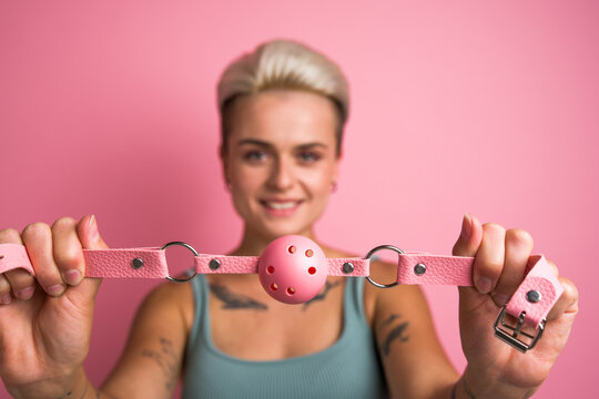 Alluring girl playing pervert fetish game and preparing closing mouth with pink gag