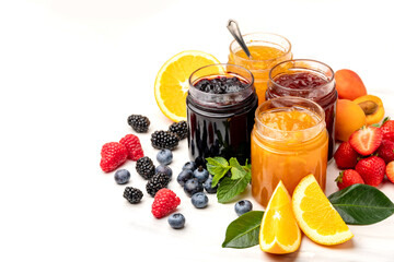 Jam in jar and berries strawberry apricot  orange, blueberries blackberries