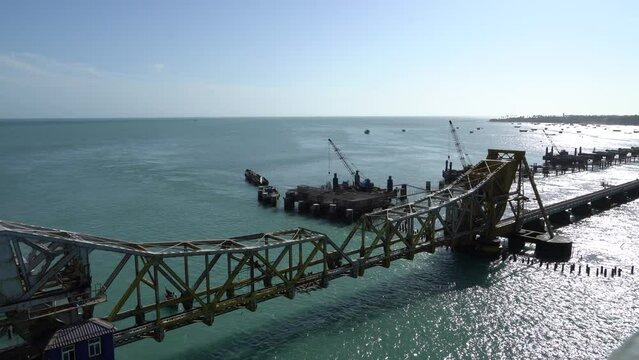 Pamban bridge at Rameshwaram, Tamilnadu. Railway bridge connects the small island in India. Blue sea water with transportation for ships in the middle of the sea.