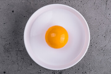 Egg yolk in bowl separated for cooking - obrazy, fototapety, plakaty