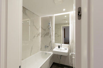 Interior of a bathroom with white marble walls