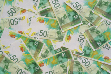 Fototapeta premium Israeli money stack of the new Israeli money bills (banknotes) of 50 shekel. New Israeli Shekel series C