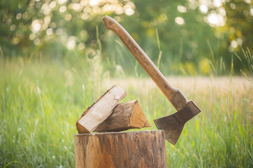 Axe and firewood on the deck outdoors. Shallow depth of field