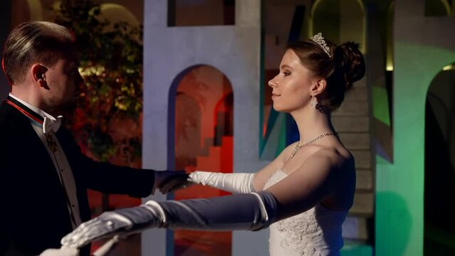 graceful young lady is dancing with elegant man in fabulous ballroom, traditional viennese ball