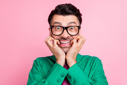 Closeup photo of young nervous guy bite fingers lips smiling can not wait salary isolated on pink color background
