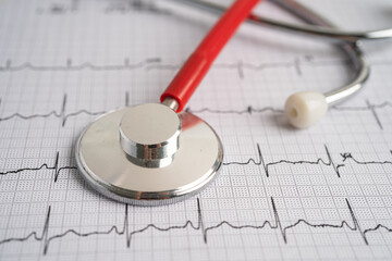 Stethoscope on electrocardiogram (ECG), heart wave, heart attack, cardiogram report.
