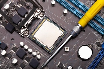 Engineering for repair and maintenance of digital technology. PC computer chip on the motherboard...