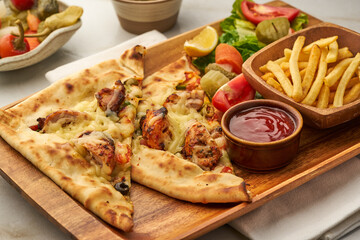 Fatayer Sheesh Tawook with fries and ketchup, salad served in a dish isolated on grey background side view of fastfood