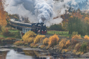 Retro steam train at autumn morning.