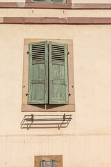 Traditional half-timbered house with old window in Alsace France. 