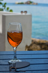 ORANGE COCKTAIL IN FRONT OF THE BLUE SEA AND SKY