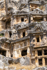 View of the Lycian tombs in the ancient city of Myra, climbed on the mountain on a sunny day.