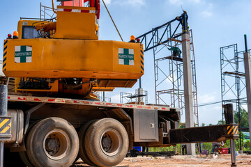 Cranes lift roof structures in industrial construction sites.
