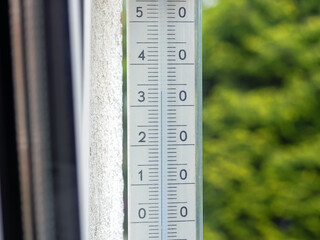 Outdoor thermometer outside the window showing the air temperature