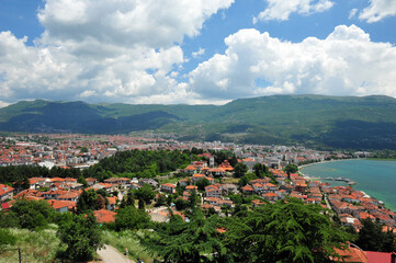 Fototapeta na wymiar View over the town Ohrid in Macedonia on a sunny summer day. Mountains in the background. Lake slightly visible.