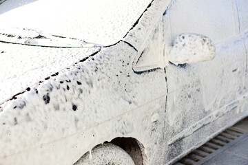 Car wash with active foam. car wash at a self-service car wash. close-up