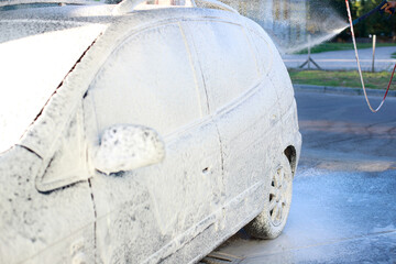 car in foam at a self-service car wash