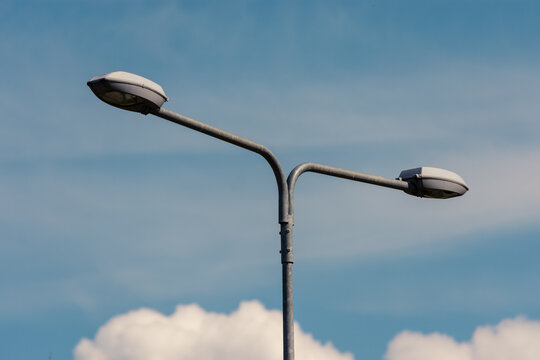 Highway street lamp divided in two to illuminate both lanes