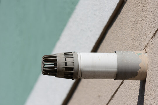 White gas boiler flue mounted on the building exterior wall. Close up shot.