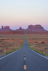 Scenic Road in the Dry Desert with Red Rocky Mountains in Background. Sunrise Sky. Forrest Gump Point in Oljato-Monument Valley, Utah, United States.