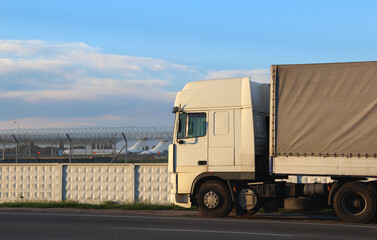 Cabin of a freight truck on the road in front of the restricted cargo airport
