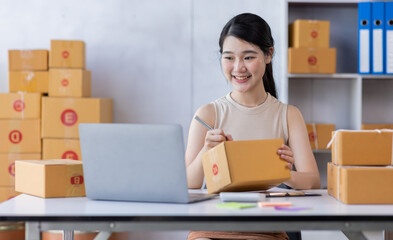 SME entrepreneur Business Young Asian freelance girl works with a laptop and box at home, about eCommerce, business, seller, Asian, employee, entrepreneur, box, merchant, Online SME business ideas,