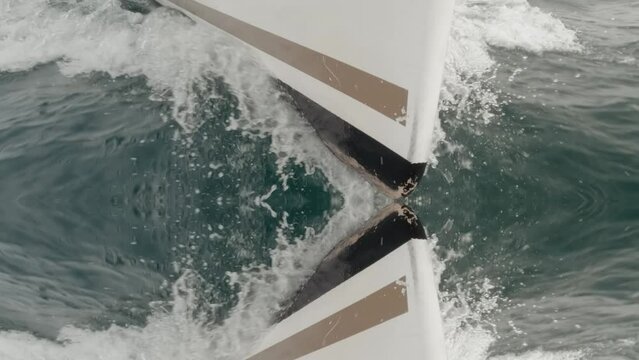 Sailboat stern reflected sailing in super slow motion